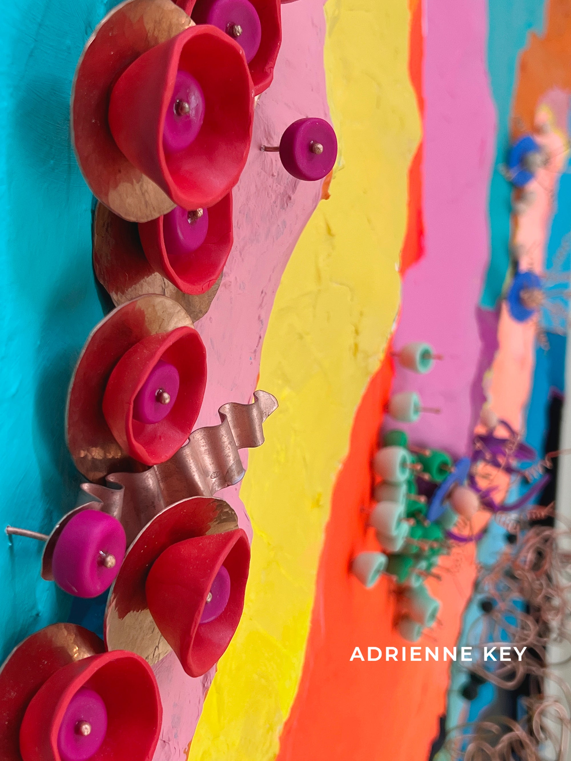 Colorful detail photo of a large 12x8 foot indoor sculpted abstract mural with bright organic details