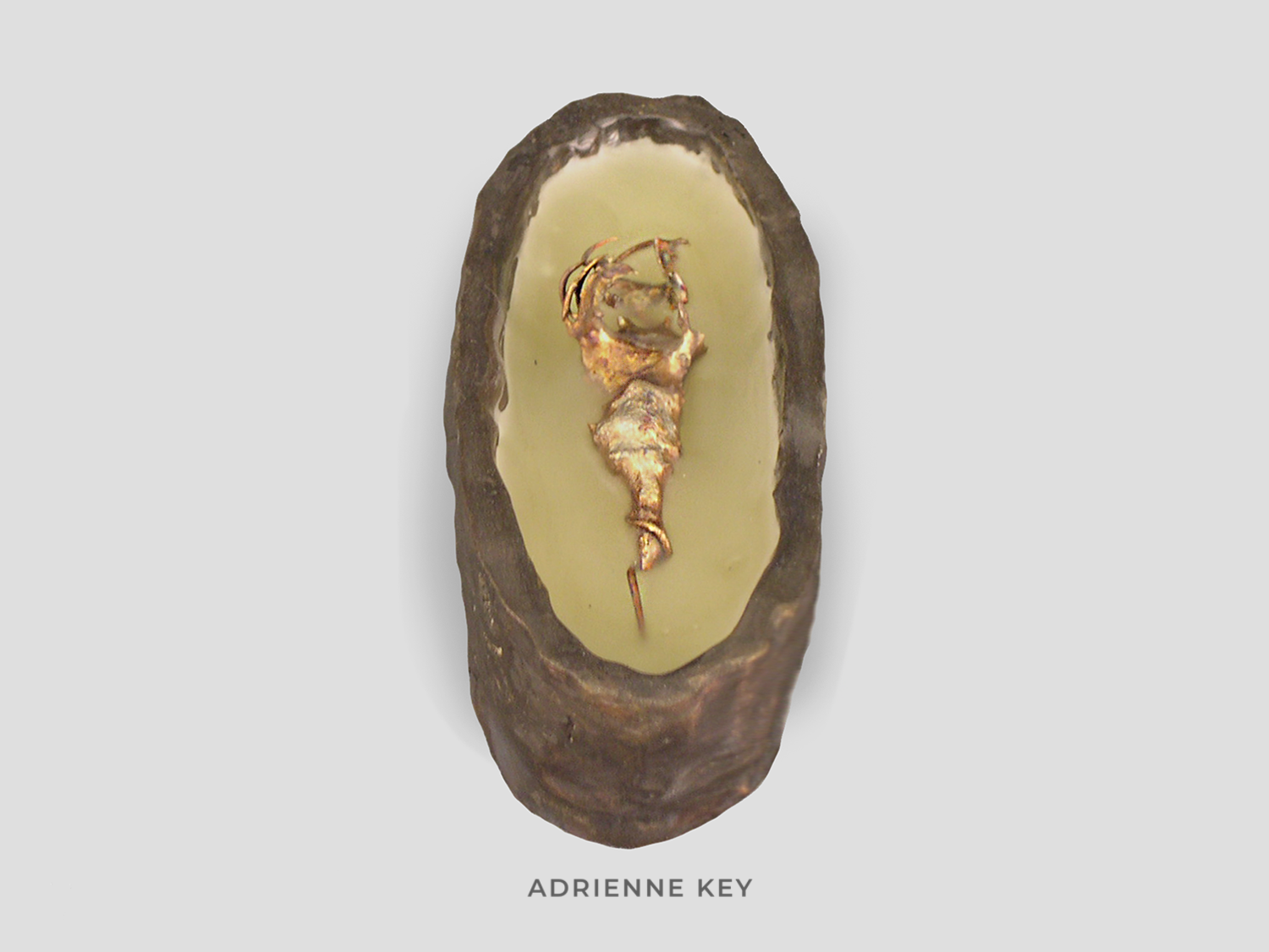 Sculpture of an oval bronze box filled with beeswax and a melted copper organic form