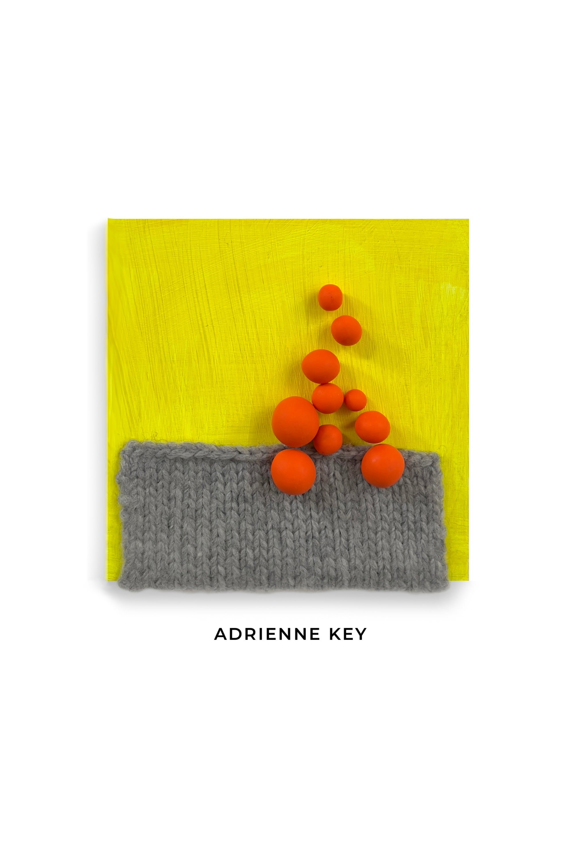 4x4 mixed media wall art with a bright yellow wood base, grey knitting and orange polymer balls